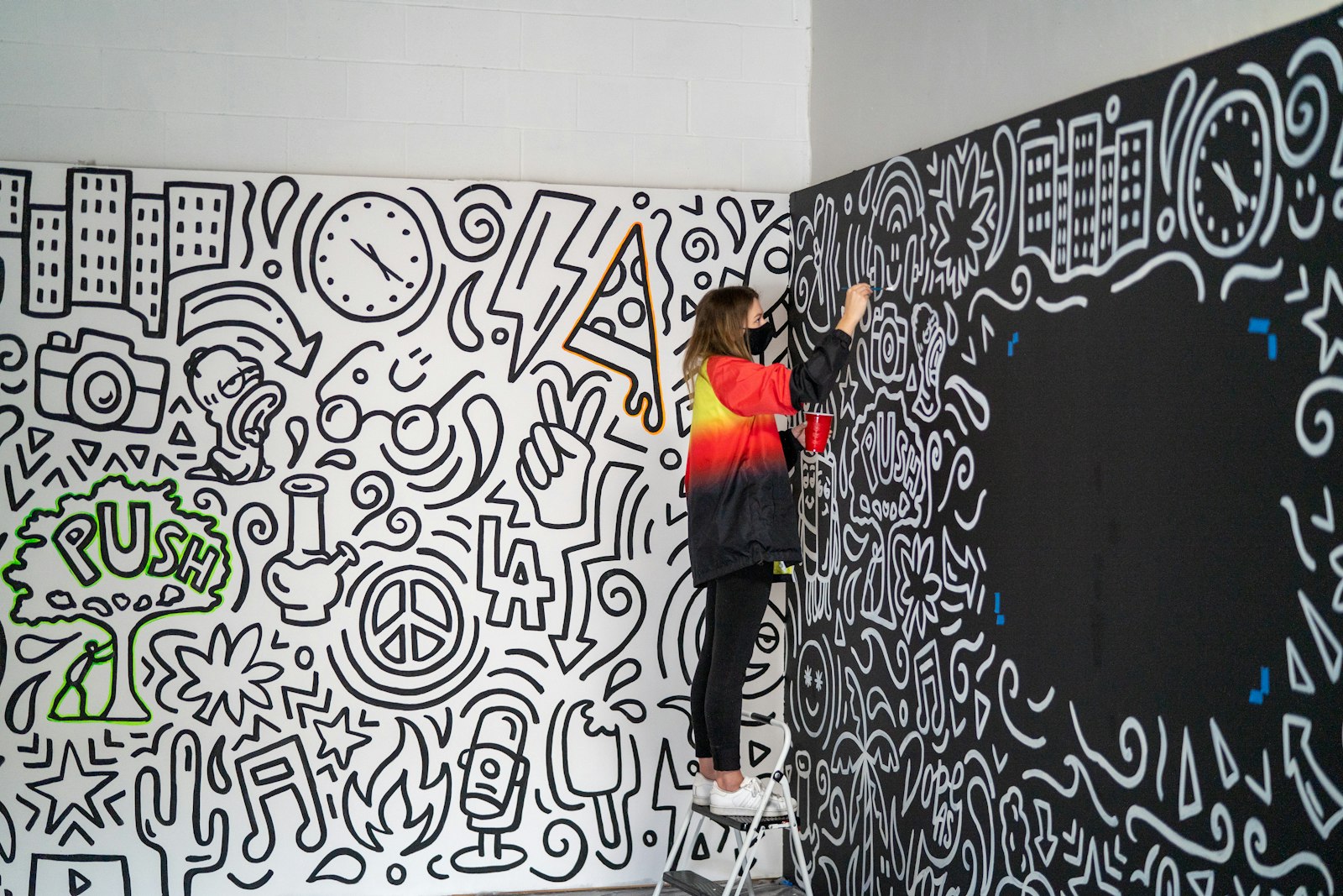 A visitor at a mural wall