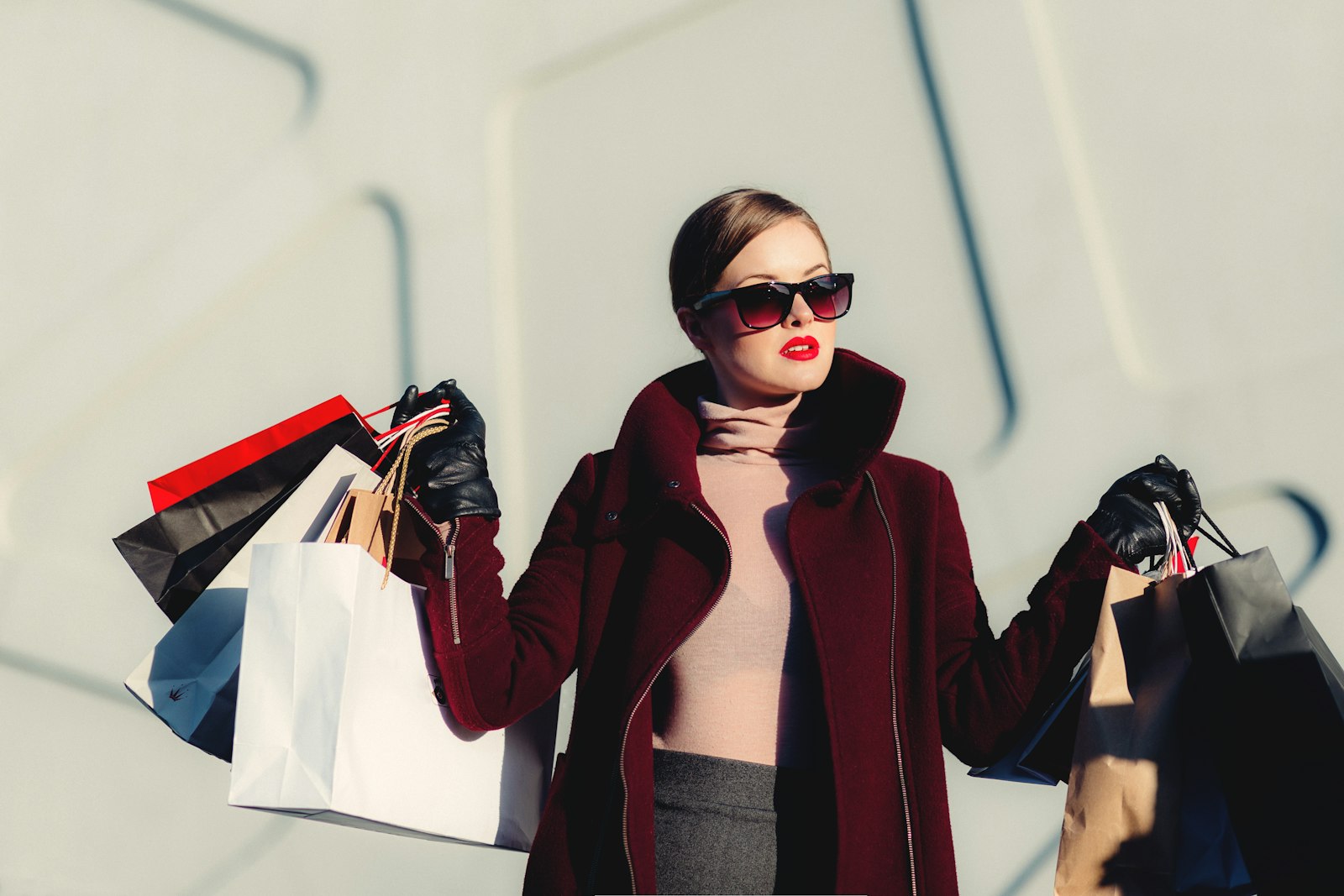 A shopper carrying colorful shopping bags